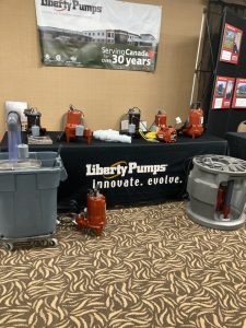 A photo of a table with a black cloth with plumbing equipment on top of it. 